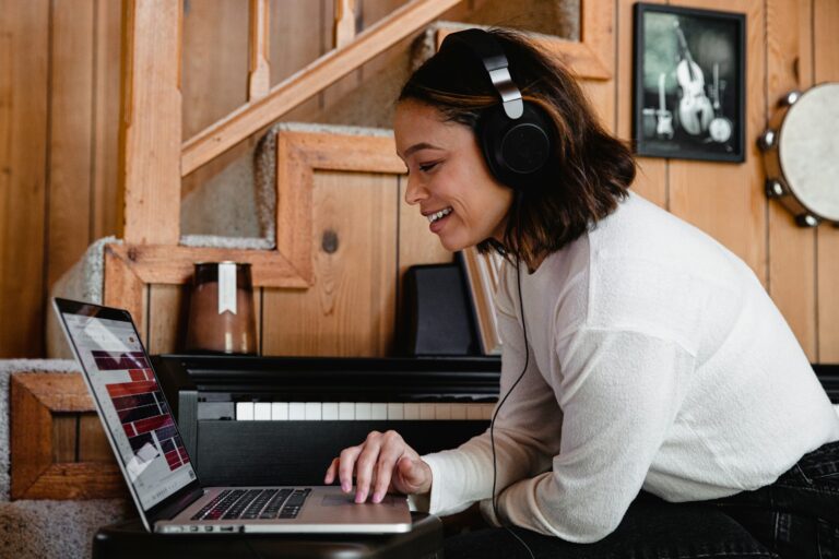 woman in gray long sleeve shirt using macbook pro