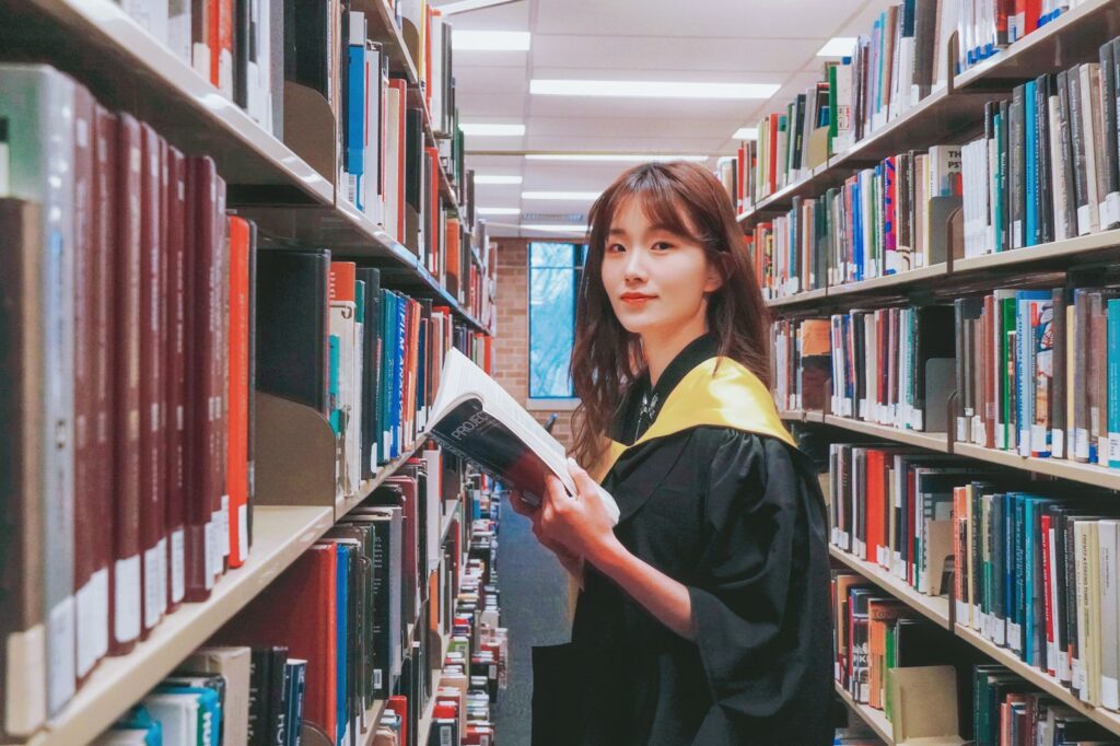 A woman in a library holding a book