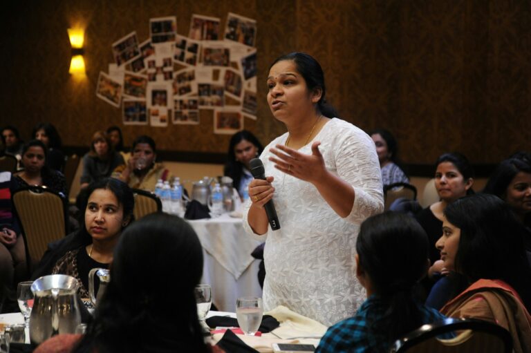 woman holding microphone for studying IELTS Speaking