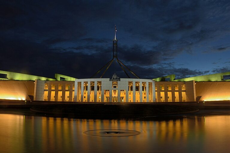 white concrete building near body of water canberra